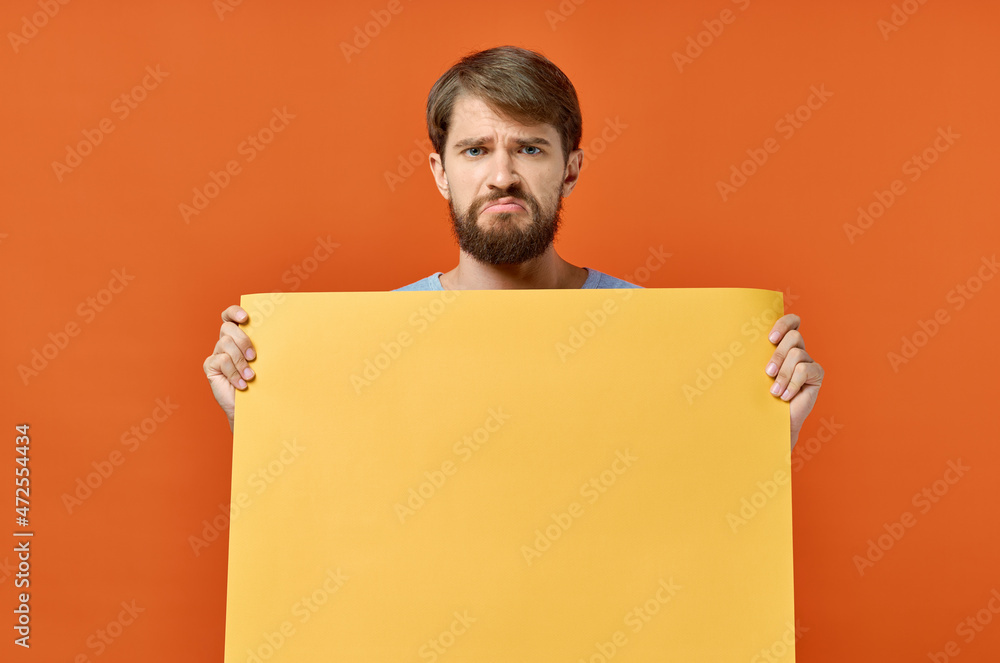 bearded man holding a yellow banner design orange background bearded man holding a yellow banner design orange background