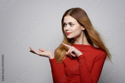 beautiful woman in red dress posing luxury hand gesture studio
