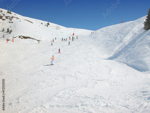Group of skiers on the mountain slope.