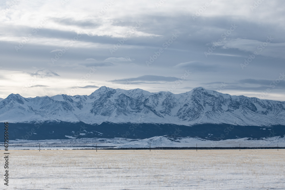 Rocky mountain range covered by snow. Mountains of Altai Republic