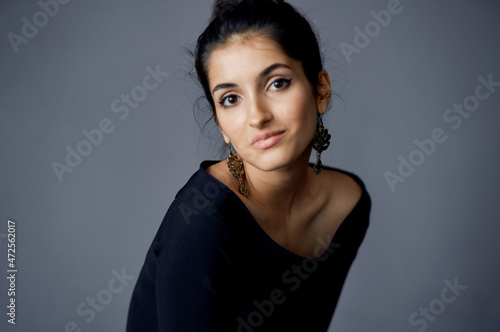 pretty woman earrings jewelry posing black dress dark background