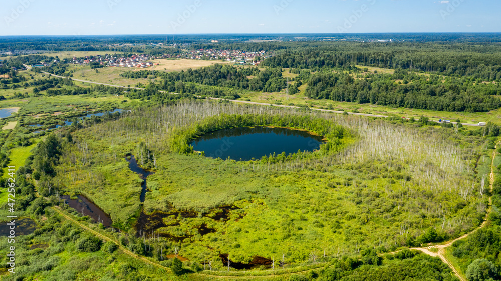 Aerial view of Bottomless  Lake in forest of Solnechnogorsk District, Moscow region. Russia. Aerial view. The lake is perfectly round and its depth is not determined.