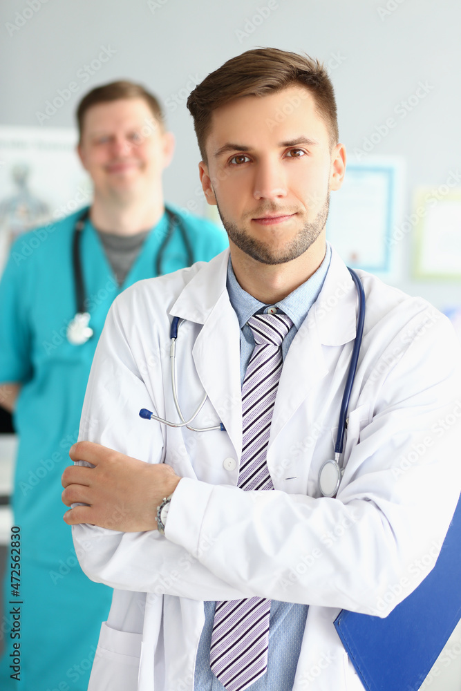 Two male medical workers in uniform at the workplace, Two male medical workers in uniform at the workplace,