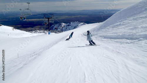 Alpine skiing and snowboarding on gentle slope at Mount Ruapehu, ski resort photo