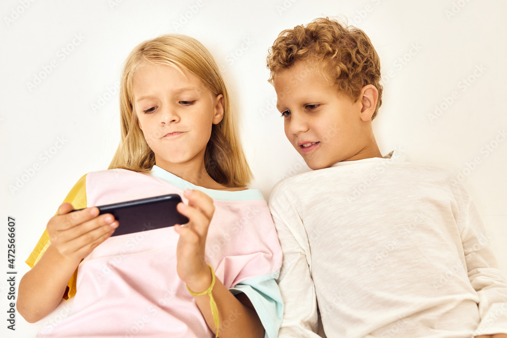 fashionable boy and girl with phone in hands game communication fashionable boy and girl with phone in hands game communication