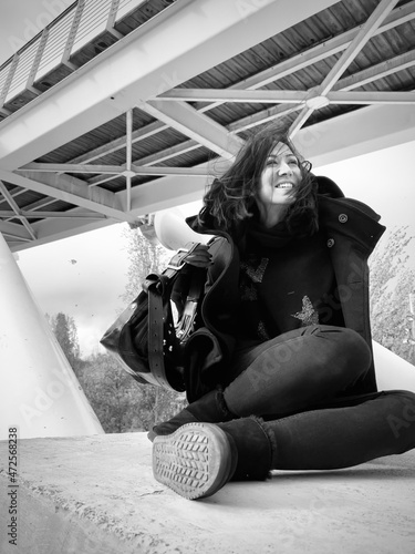 woman sitting smiling with wind blowing through her hair