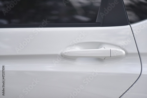 close up of white car door handle