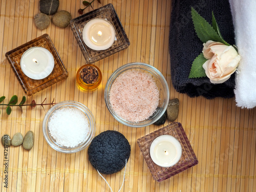 Home skin care. Himalayan salt, sea salt, almond oil, towels and candles. Flat lay