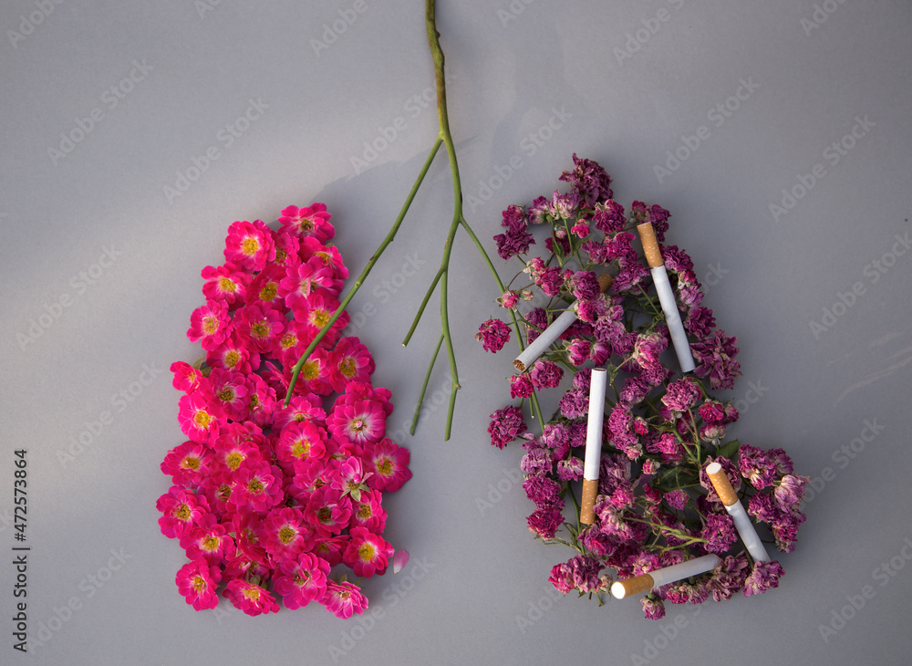 pink rose flowers on one side and dried flowers with cigarettes are