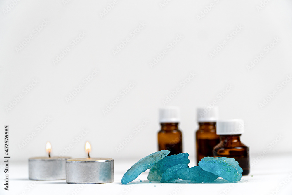 sea salt,candles and aromatic oils in bottles on a white background. Accessories for massage in the spa salon. The concept of cosmetic procedures. sea salt,candles and aromatic oils in bottles on a white background. Accessories for massage in the spa salon. The concept of cosmetic procedures.