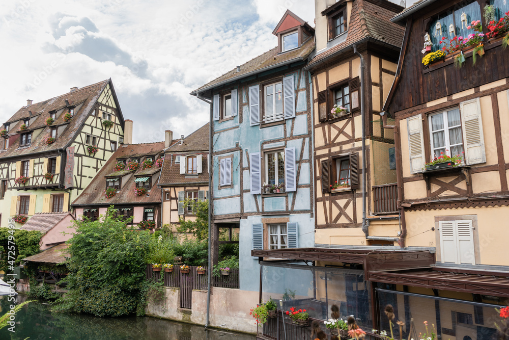 Famous Colmar city view with little venice water channel traditional half timbered houses in Alsace , France.Tourist destination in France. Famous Colmar city view with little venice water channel traditional half timbered houses in Alsace , France.Tourist destination in France.