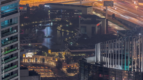 Aerial view of Dubai Internet City Lake and Buildings night timelapse