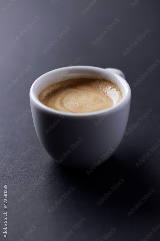 Cup of coffee on dark paper background. Close up. Cup of coffee on dark paper background. Close up.