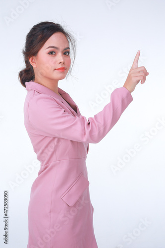 Young business charming confident woman in pink suit at the studio white background.