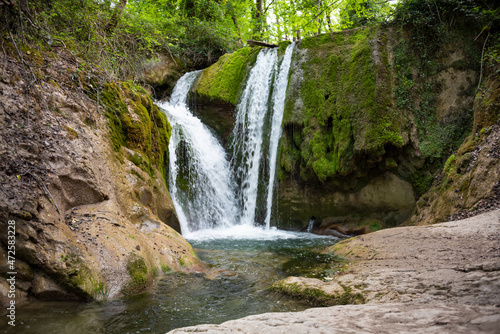 Fototapeta Naklejka Na Ścianę i Meble -  Beautiful waterfall in green forest among trees