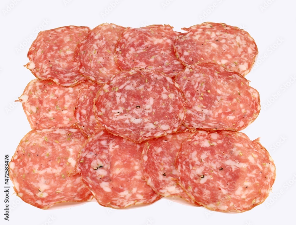 Slices of Finocchiona on white background. It is a traditional salami from Tuscany charaterized by the use of fennel seeds. Slices of Finocchiona on white background. It is a traditional salami from Tuscany charaterized by the use of fennel seeds.