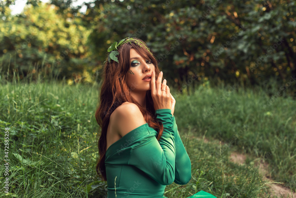 Young woman in green dress in the park Young woman in green dress in the park