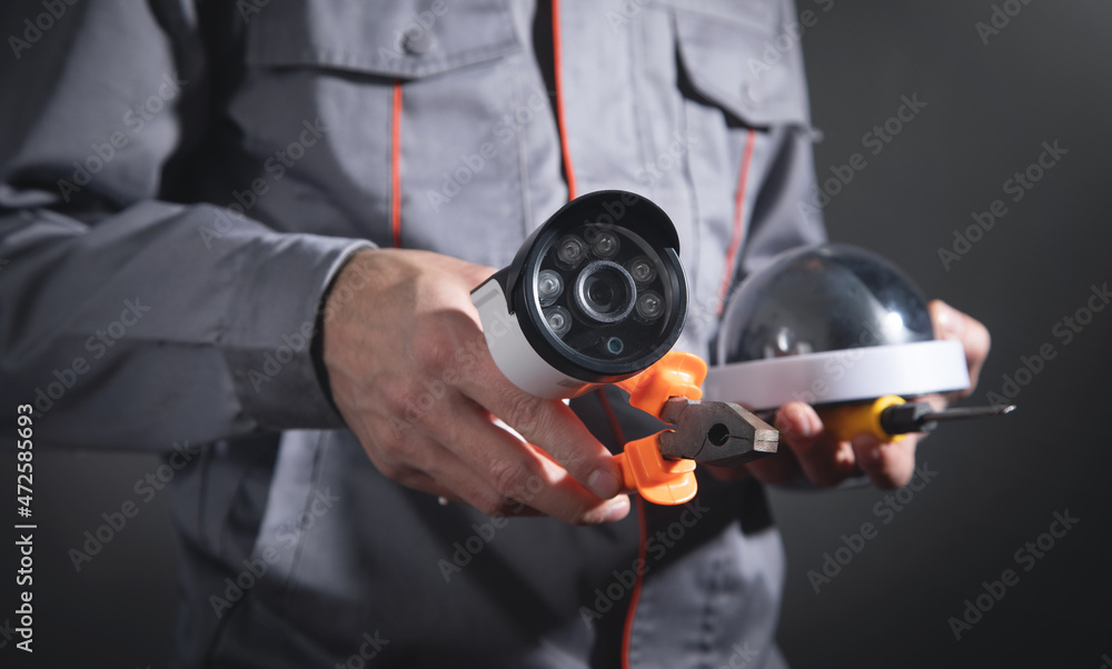 Man holding surveillance security camera. Man holding surveillance security camera.