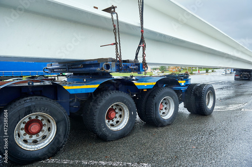 back of a truck with a special trailer for transporting two concrete beams © Javi