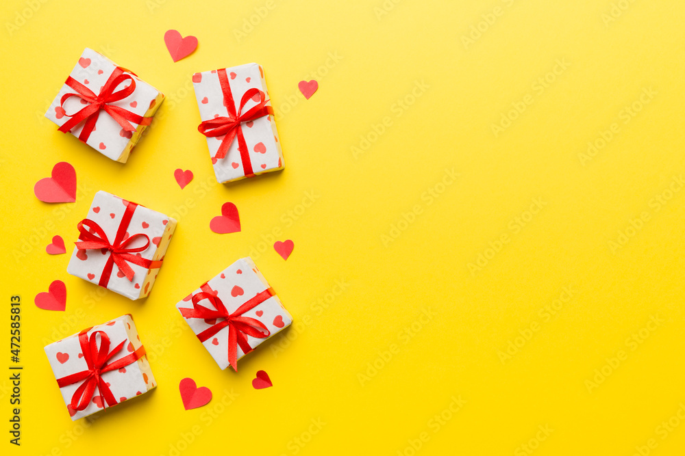 Valentine day composition: red gift box with bow and heart. Christmas present. View from above. Space for text. Holday greeting card Valentine day composition: red gift box with bow and heart. Christmas present. View from above. Space for text. Holday greeting card