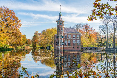 Bouvigne Castle reflected in the mirroe smooth water surface. The castle is sitated near the Dutch city of Breda. It is a sunny day in the autumn season. photo