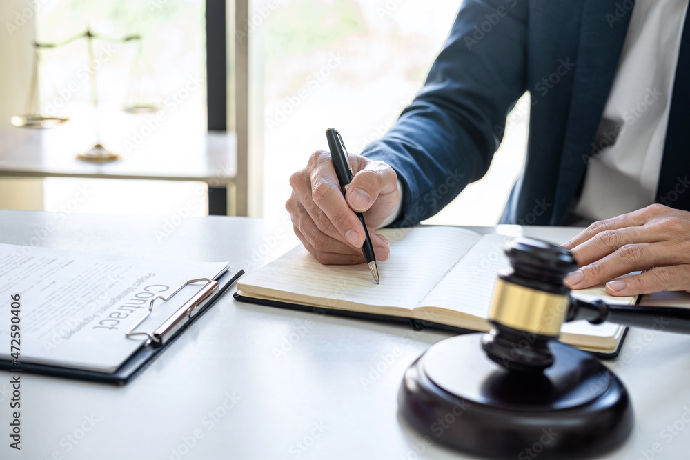 Judge gavel with Justice lawyers, Businessman in suit or lawyer working on a documents in courtroom. Legal law, advice and justice concept Judge gavel with Justice lawyers, Businessman in suit or lawyer working on a documents in courtroom. Legal law, advice and justice concept