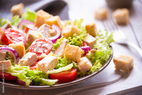 Caesar salad with vegetables, chicken and croutons