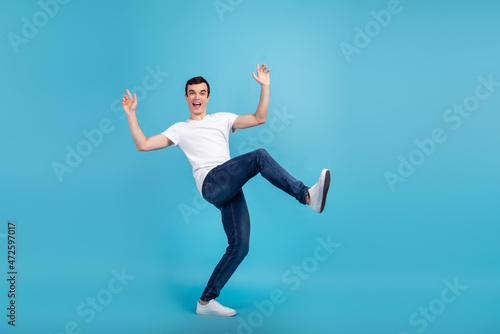 Full size profile side photo of young excited man have fun playful fool isolated over blue color background