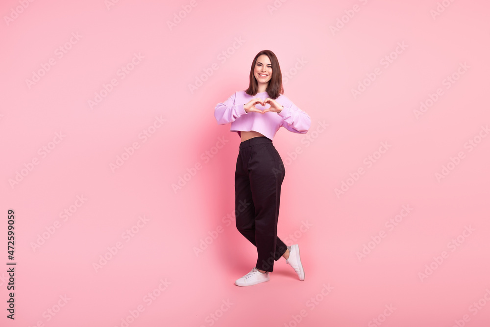 Full size profile side photo of young attractive woman show fingers heart symbol love isolated over pink color background Full size profile side photo of young attractive woman show fingers heart symbol love isolated over pink color background