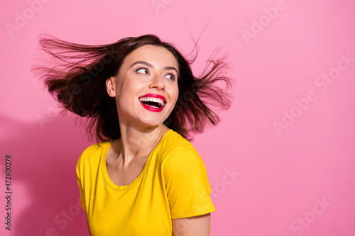 Portrait of attractive cute shine cheerful girl having fun throwing hair copy space isolated over pink pastel color background