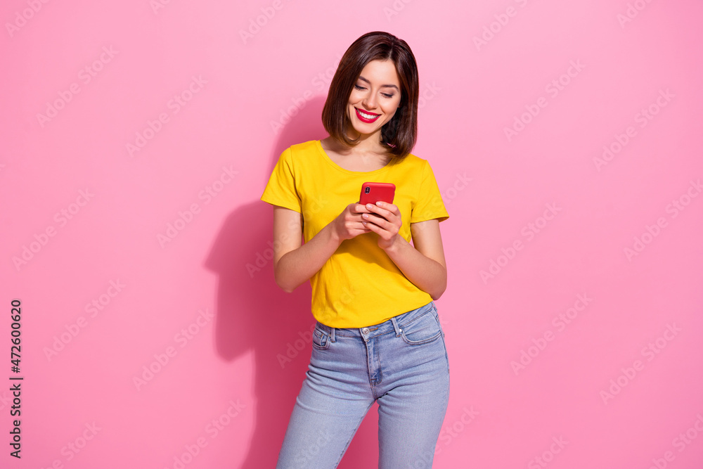 Portrait of attractive cheerful girl using device like follow smm post isolated over pink pastel color background Portrait of attractive cheerful girl using device like follow smm post isolated over pink pastel color background