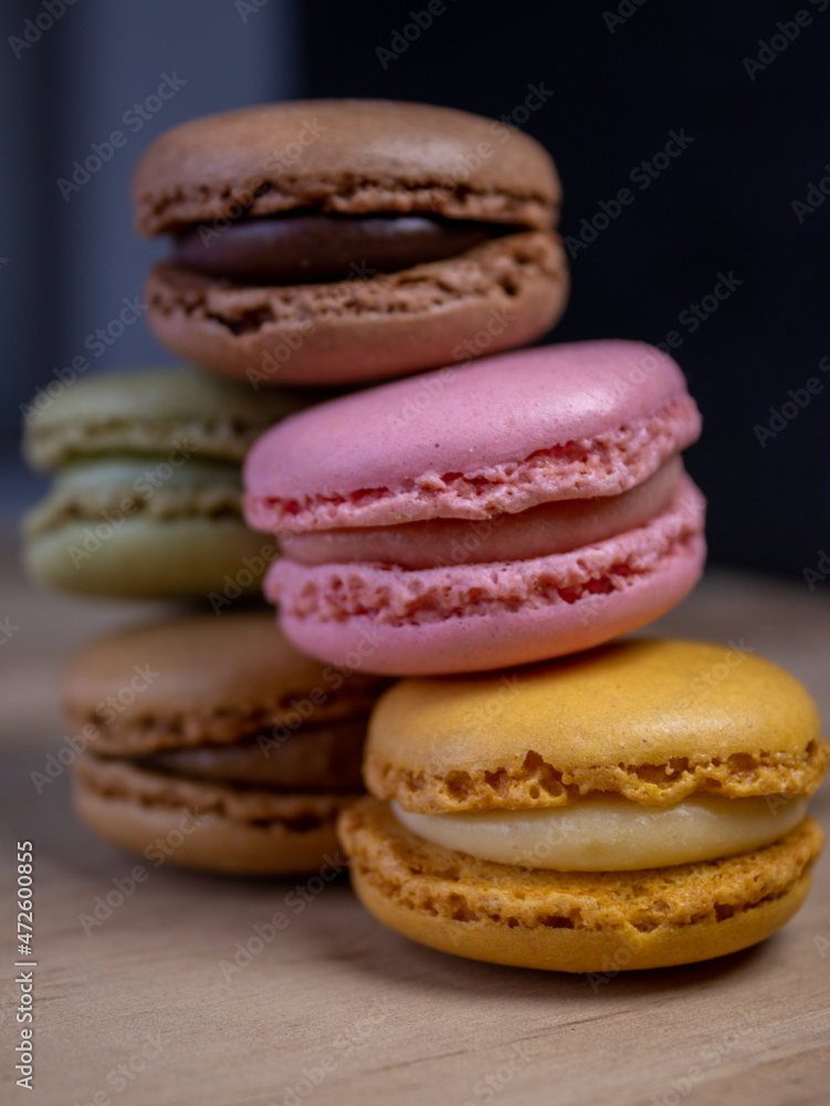 Colorful cakes on wooden table, close up view Colorful cakes on wooden table, close up view