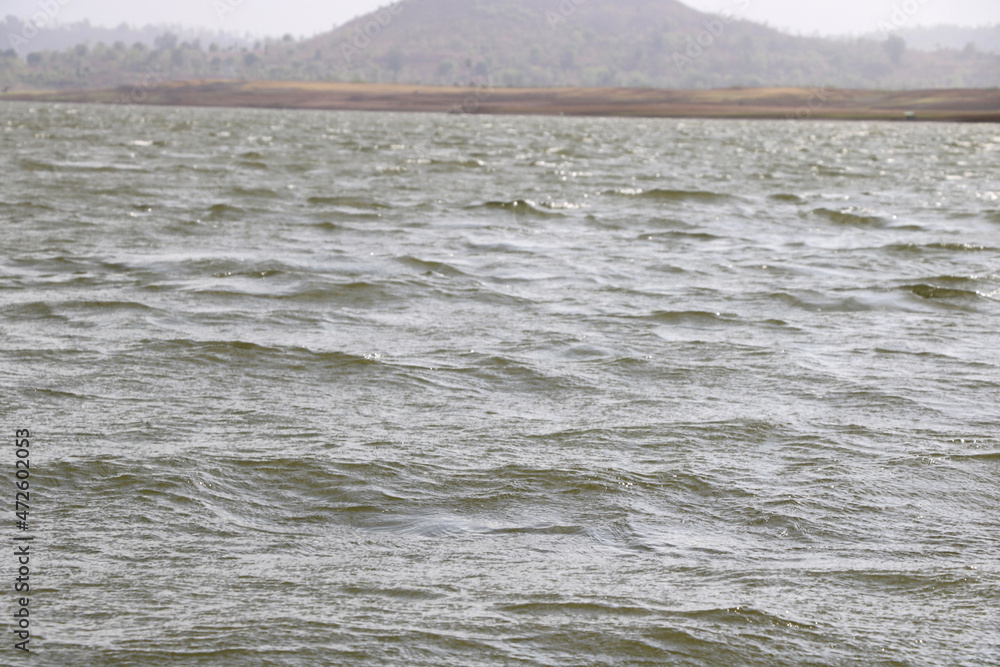 landscape view of river bank with dry land and hill on background from boat landscape view of river bank with dry land and hill on background from boat