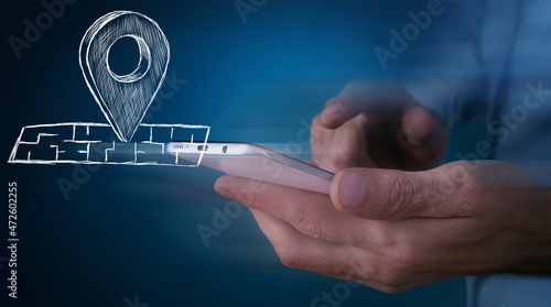 Obraz na plátne hand presses the geolocation icon on the map on the phone
