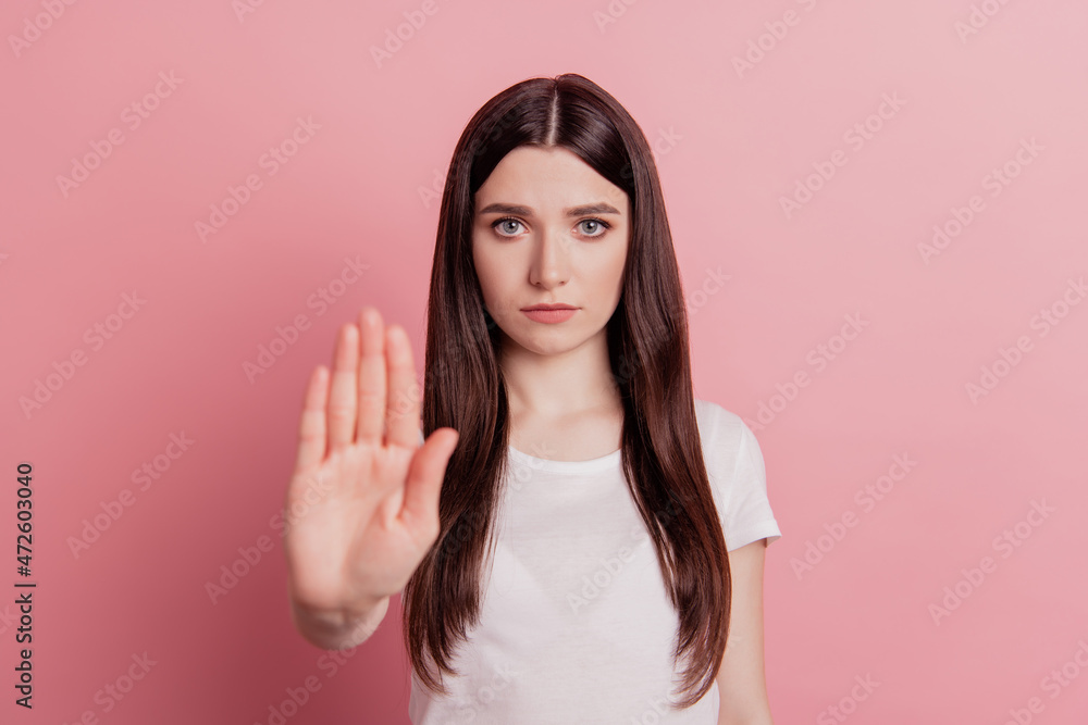 Portrait of serious strict girl show hand no stop sign reject refuse forbidden decline isolated over pastel color background Portrait of serious strict girl show hand no stop sign reject refuse forbidden decline isolated over pastel color background