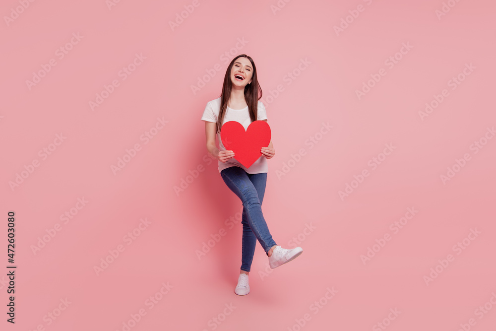 Full length photo of young attractive girl happy positive smile hold big red paper heart isolated pink color background