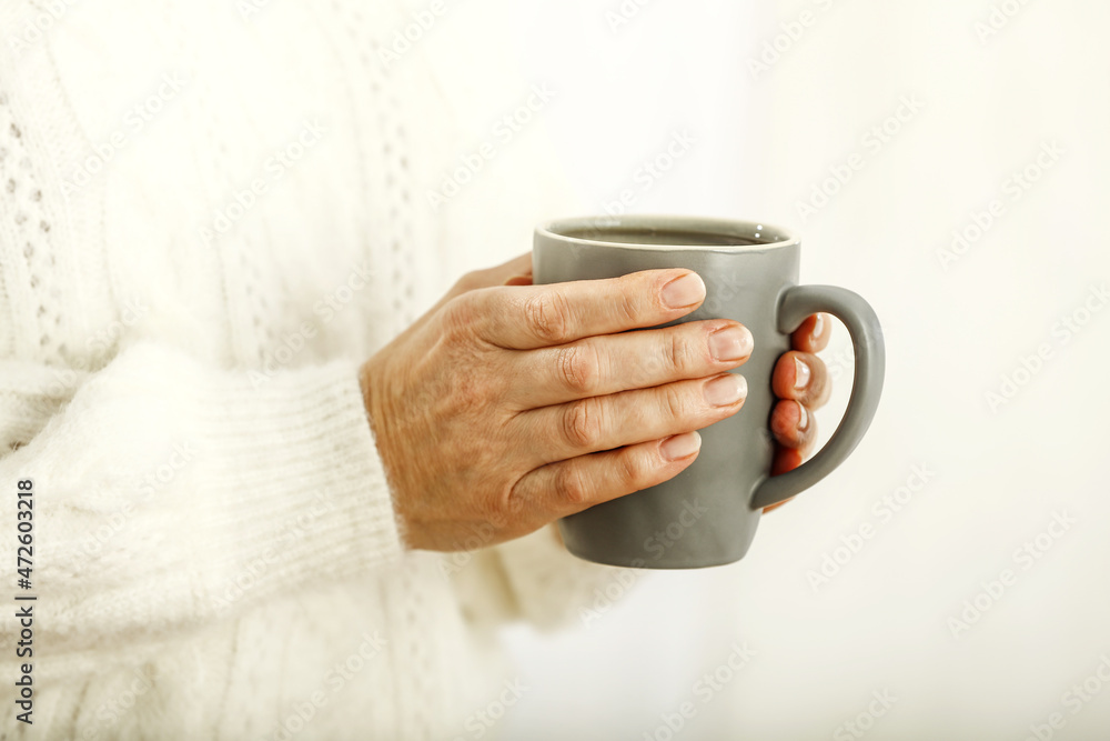 Woman hands and mug with hot drink Woman hands and mug with hot drink