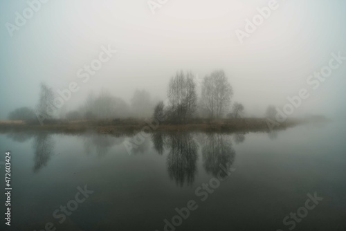Autumn river in the morning in thick fog