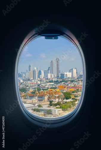 View of Bangkok, Thailand. looking through the window of an airplane. The city is full of stories of cultural differences, old and new.
