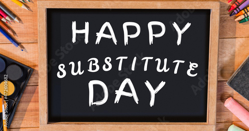 Image of happy substitude day text over blackboard
