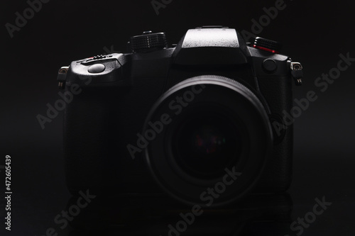 New photo camera on black background closeup