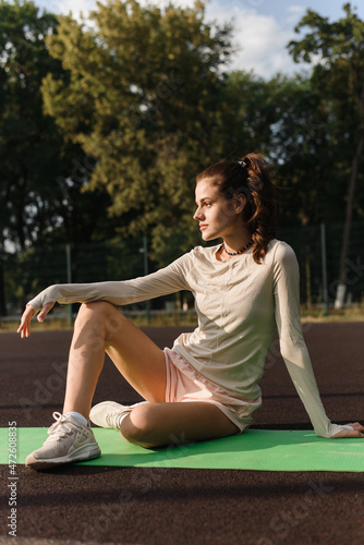 Portrait of a girl resting after outdoor workout. Take a break after yoga or stretching © etonastenka