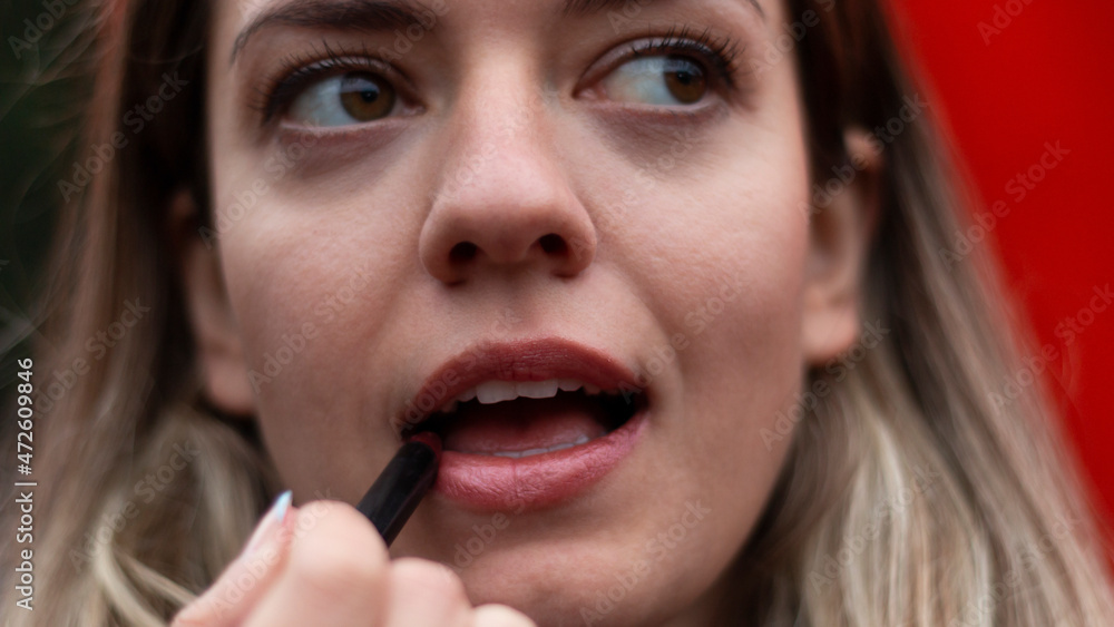 Beautiful young woman with bright blue makeup. Beautiful brunette with bright pinklipstick on her lips. Close up face of brunette woman. Beautiful young woman with bright blue makeup. Beautiful brunette with bright pinklipstick on her lips. Close up face of brunette woman.