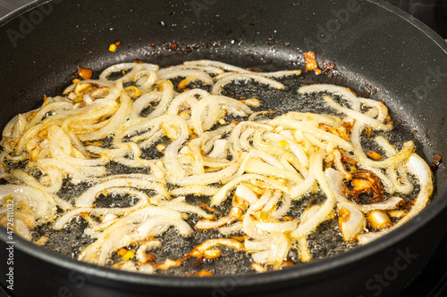 fry chopped onion rings in vegetable sunflower oil in a Teflon pan