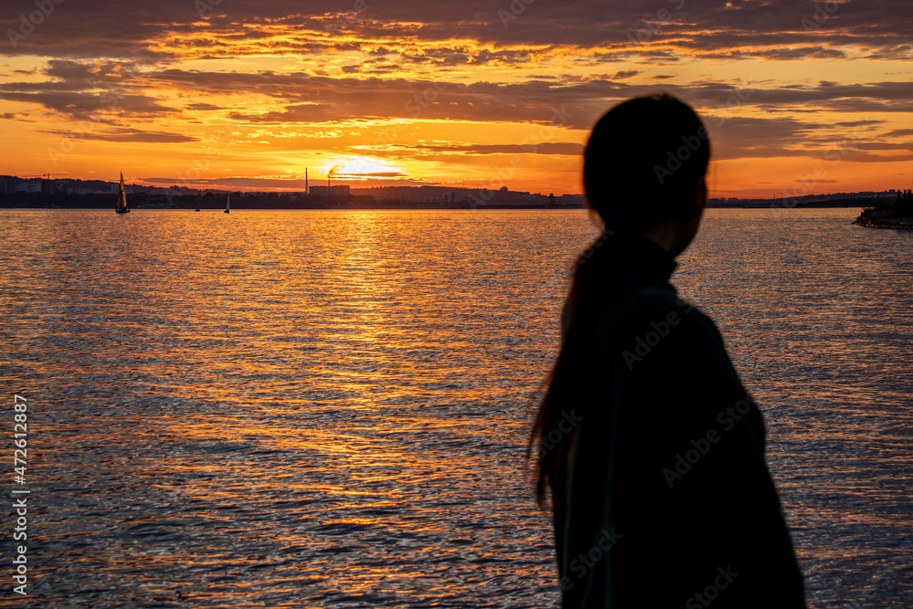 silhouette of a person on the beach at sunset