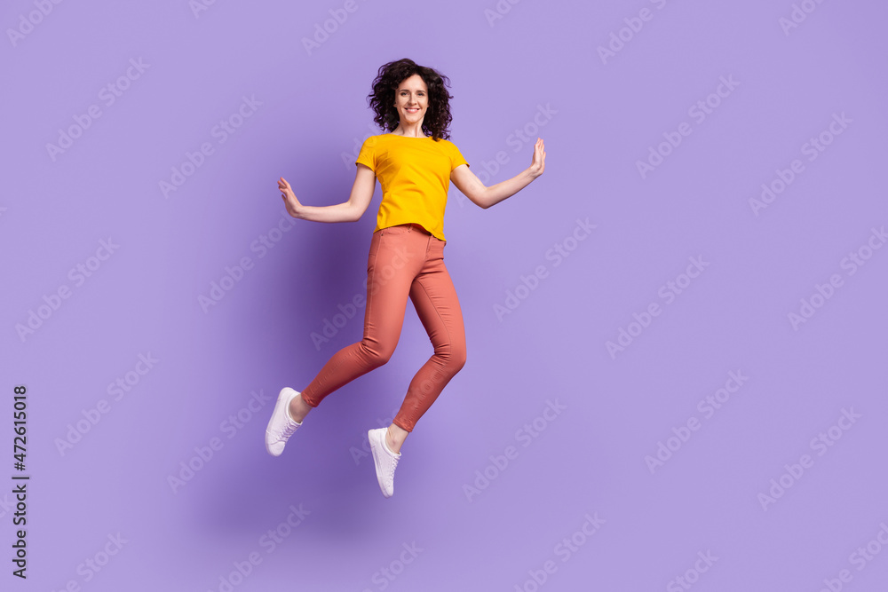 Full size photo of young lovely woman good mood energetic jump up isolated over violet color background