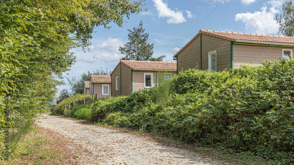 Row of holiday cabins against a blue sky