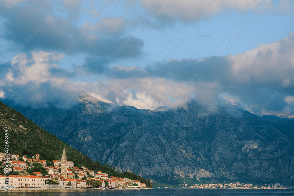 Perast coastline with old houses against a cloudy sky. Montenegro