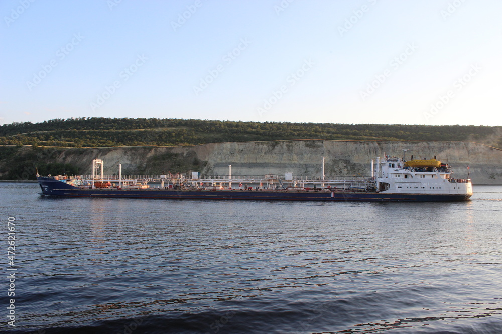 The Volga River. A river oil tanker sailing along a steep bank.
