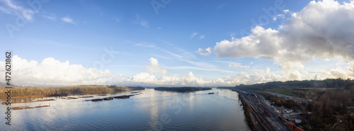 View of Fraser River and Mountain Landscape in background. Sunny Cloudy Fall Season. Aerial Scene from Port Mann Bridge in Coquitlam, Vancouver, British Columbia, Canada. Panoramic View